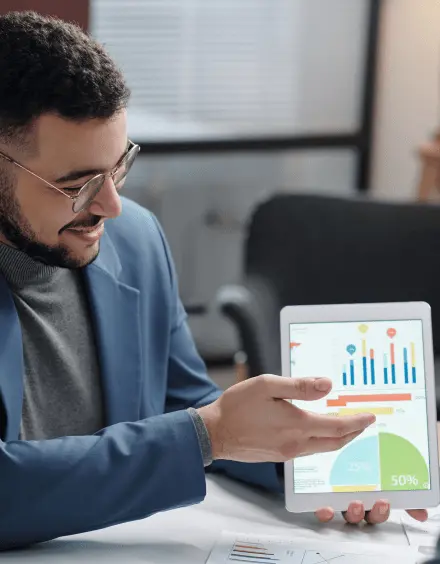 Digital marketing pro presenting PPC results on tablet with charts, for advertising services India